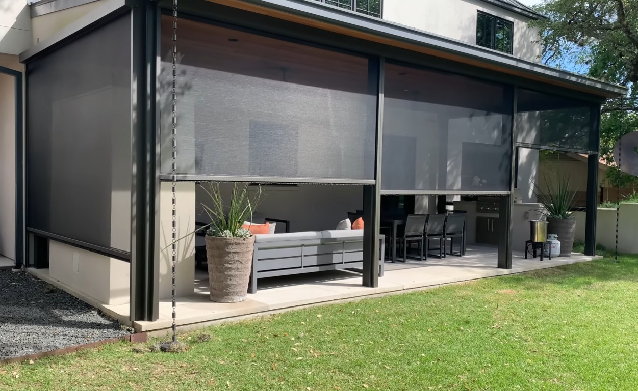 Modern patio enclosure with retractable screens and contemporary design
