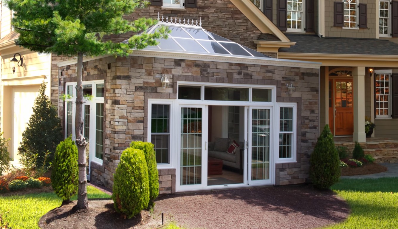 Professionally built sunroom with stone facade and French doors